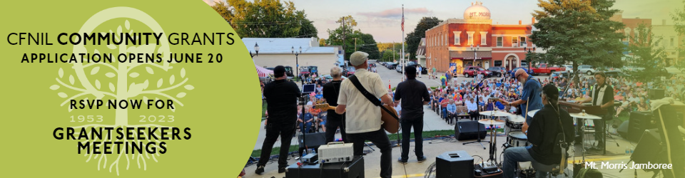 picture of a band playing on an outdoor stage in front of a crowd of people