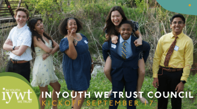 Group of students smile and laugh while outdoors in a natural setting.