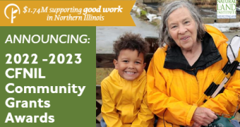 Picture of an older woman and a young boy, each wearing a bright yellow jacket, smiling at the camera. Text reads: $1.74M supporting good work in Northern Illinois. Announcing: 2022 - 2023 CFNIL Community Grants Awards