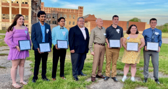 Picture of people standing outside in front of a red and white building.