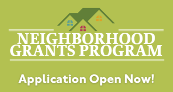 light green background. icon of a rooftop and windows, with the words Neighborhood Grants Program below. Text at bottom reads Application Open Now!
