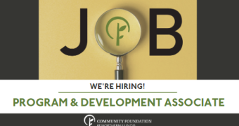 the word JOB with a magnifying glass forming the letter "O". Text below reads We're Hiring! Program & Development Associate