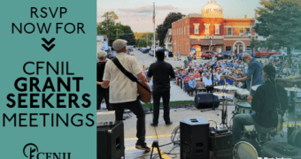 picture of a band playing on an outdoor stage in front of a crowd of people